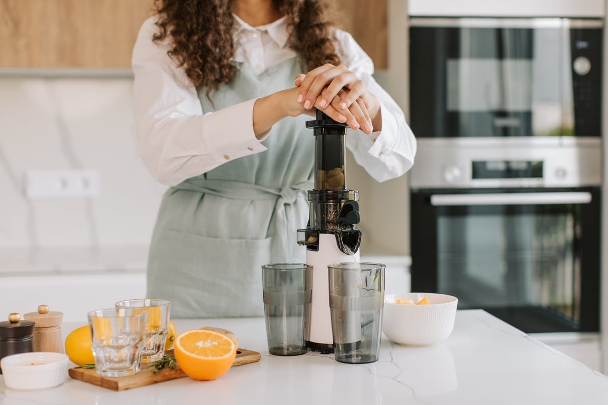 Woman Making Homemade Orange Juice