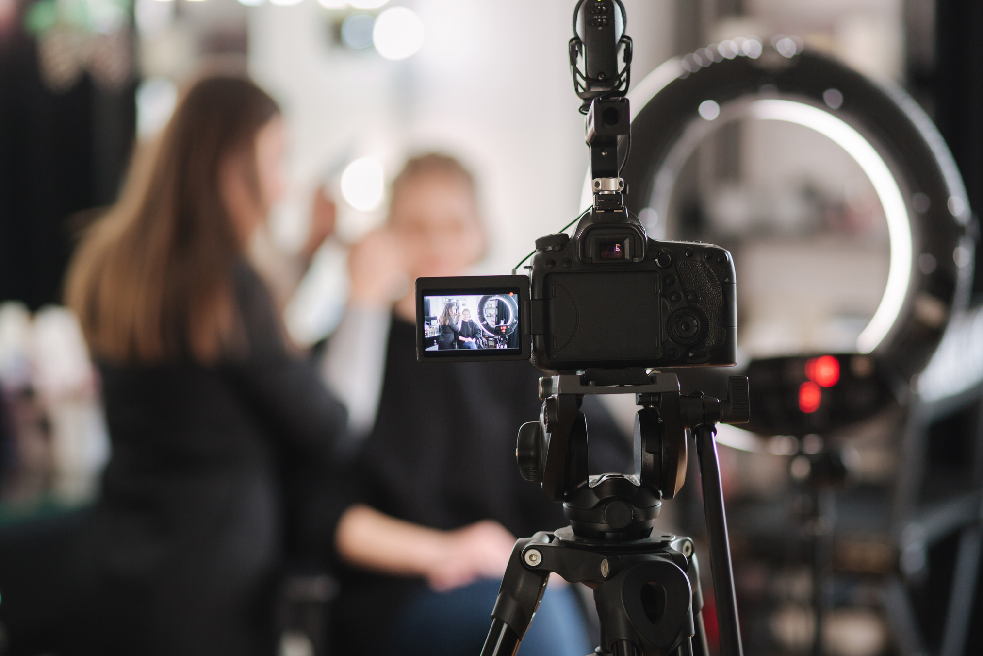 Camera and Ringlight Facing Model Getting Makeup